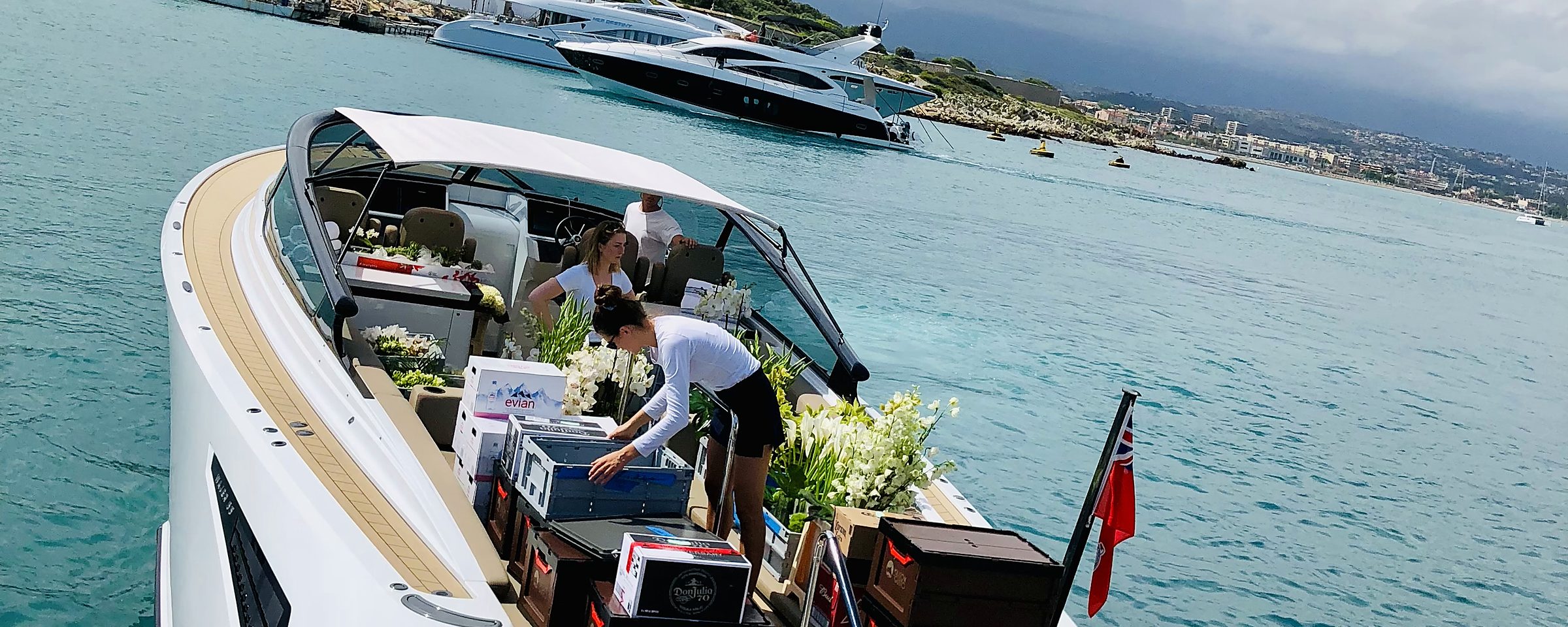 Crew loading fresh flowers onto a tender off Port Vauban, Antibes