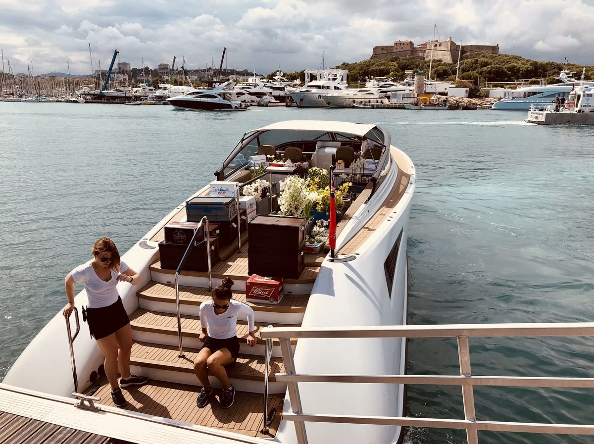 Crew on the aft deck of a superyacht with fresh flowers