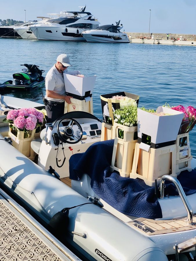 Flower boxes loaded onto a yacht tender at the quay