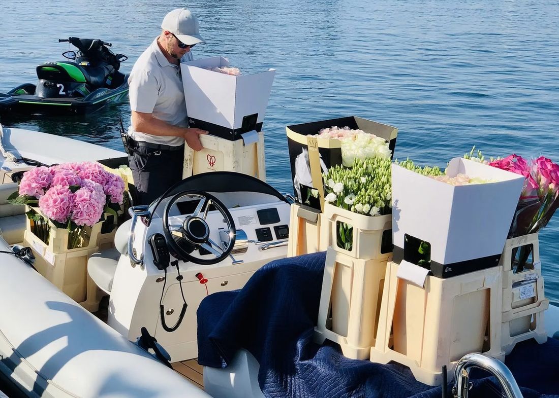 Boxes of flowers being handed into the tender