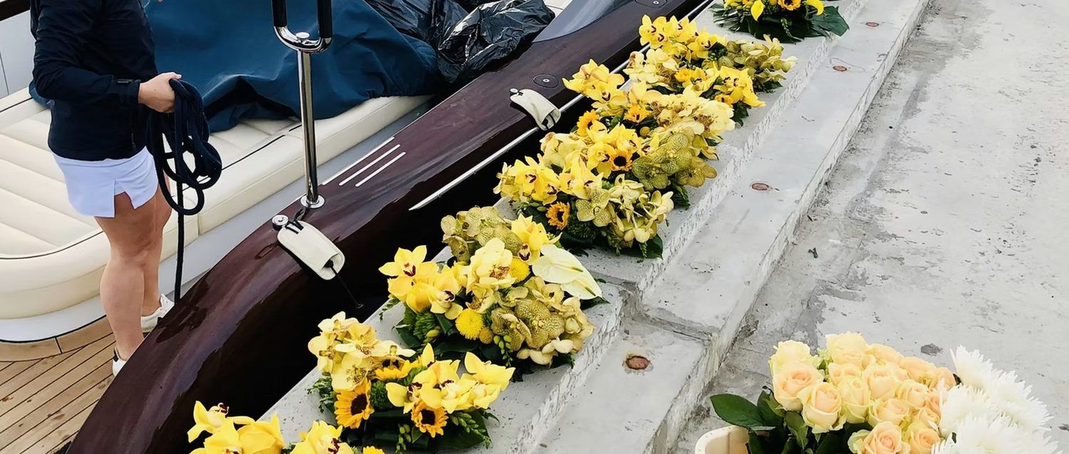 Flowers waiting on the quay beside a tender before delivery to a yacht
